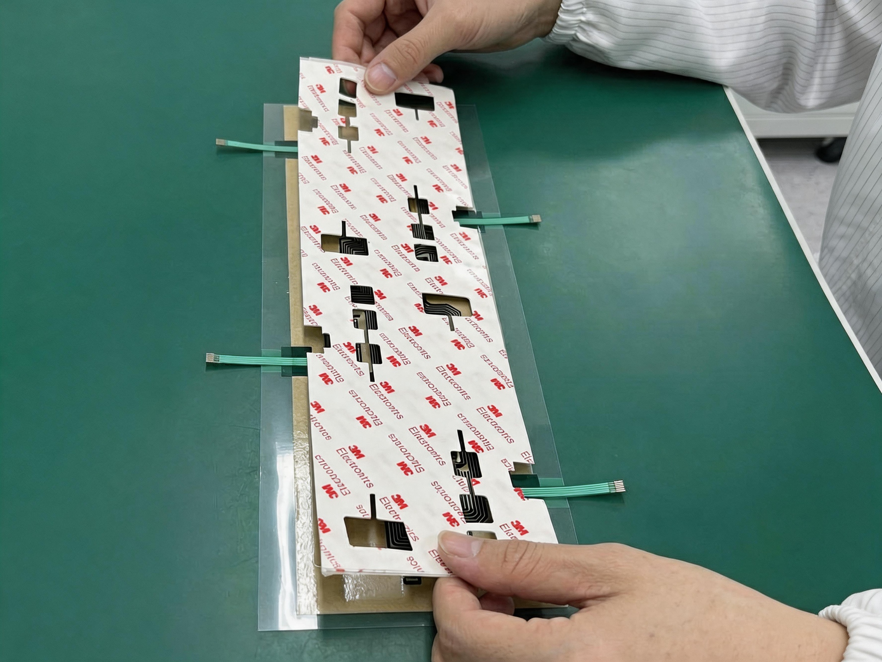 Membrane switch assembly with adhesive and flexible tails
